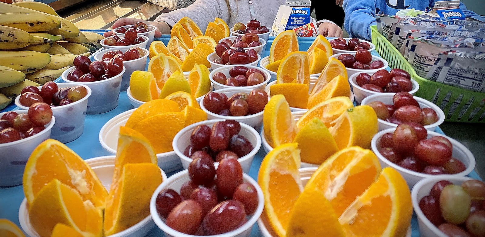 Fruit for school lunches are arranged for students on Tuesday Sept. 13, 2022 at Indian Riffle Elementary School in Kettering. MARSHALL GORBY\STAFF