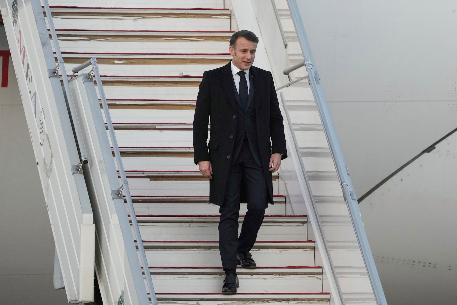 French President Emmanuel Macron gets off from his plane as he arrives at Beirut's Rafic Hariri International Airport in Beirut, Lebanon, Friday, Jan. 17, 2025. (AP Photo/Hassan Ammar)