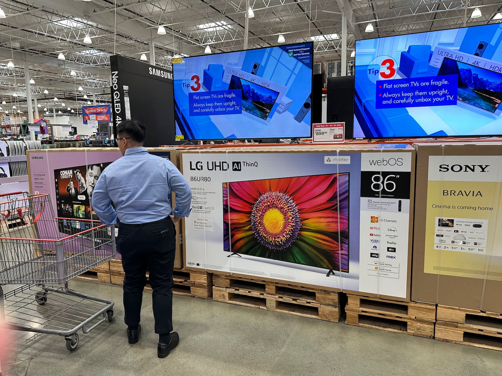 FILE - A shopper considers large-screen televisions on display in a Costco warehouse Oct. 3, 2024, in Timnath, Colo. (AP Phogto/David Zalubowski, File)