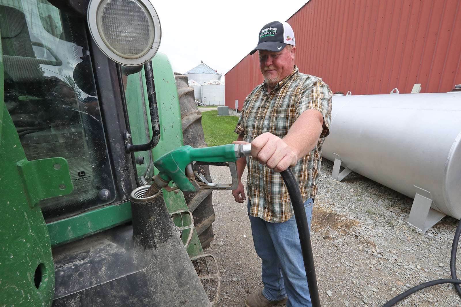 Brian Harbage fuels up one of his tractors Thursday, June 9, 2022 on his farm near South Charleston. BILL LACKEY/STAFF