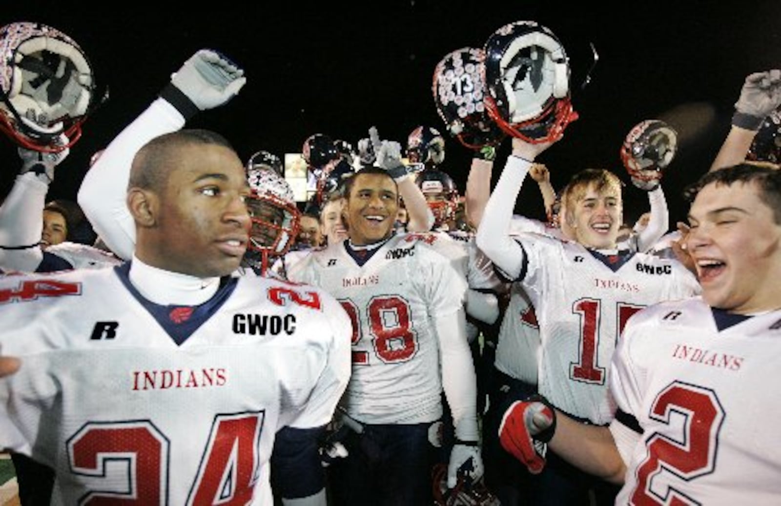 Piqua's Brandon Saine, center, is all smiles as his team celebrates after Piqua beat Pickerington Central 26-7, in the Division II high school championship football game at Paul Brown Tiger Stadium, Friday, Dec. 1, 2006 in Massillon, Ohio. (AP Photo/Tony Dejak)