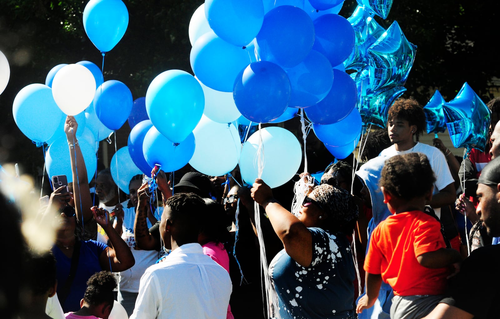 Over one hundred people turned out for a balloon release Sunday, June 30, 2024 in Dayton for a young man that was shot and killed by Dayton Police. MARSHALL GORBY\STAFF