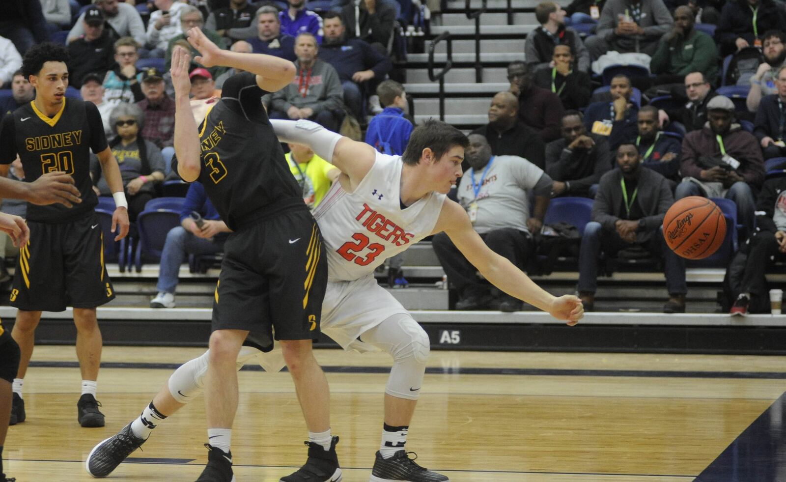 Sidney’s Kyle Jones (3) and Josiah Hudgins of Versailles. Versailles defeated Sidney 65-50 in the 16th annual Premier Health Flyin’ to the Hoop at Trent Arena in Kettering on Sun., Jan. 14, 2018. MARC PENDLETON / STAFF