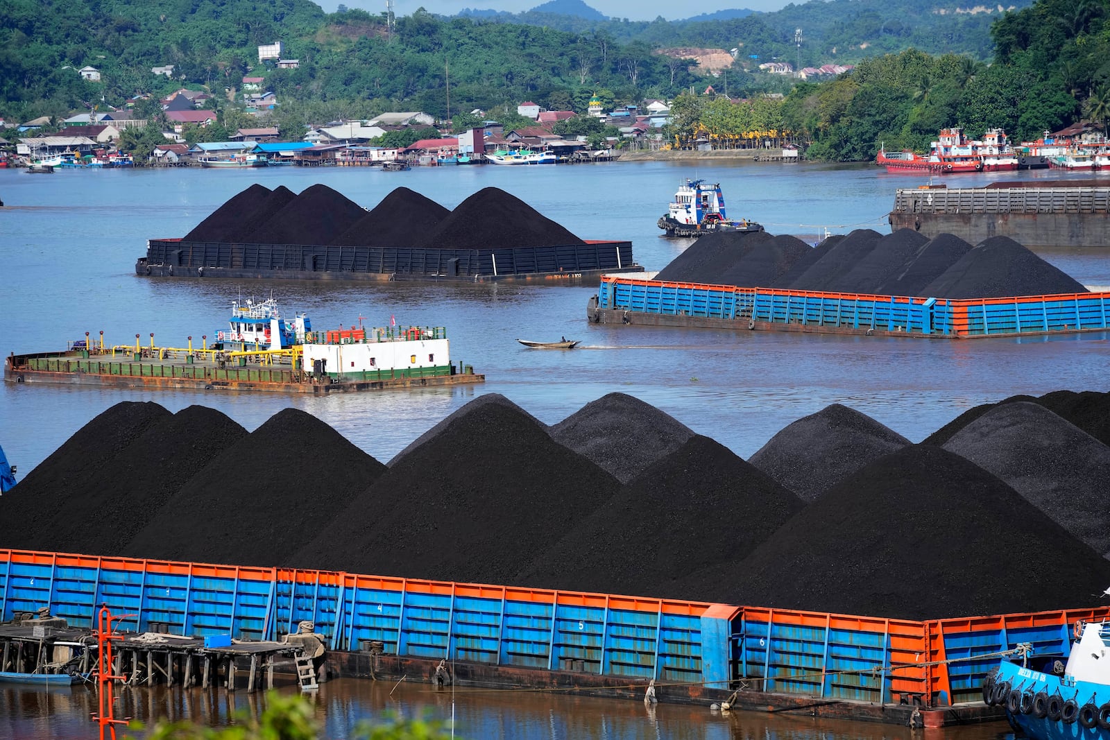 FILE- Barges fully loaded with coal are anchored on Mahakam river in Samarinda, East Kalimantan, Indonesia, on Dec. 19, 2022. (AP Photo/Dita Alangkara, File)