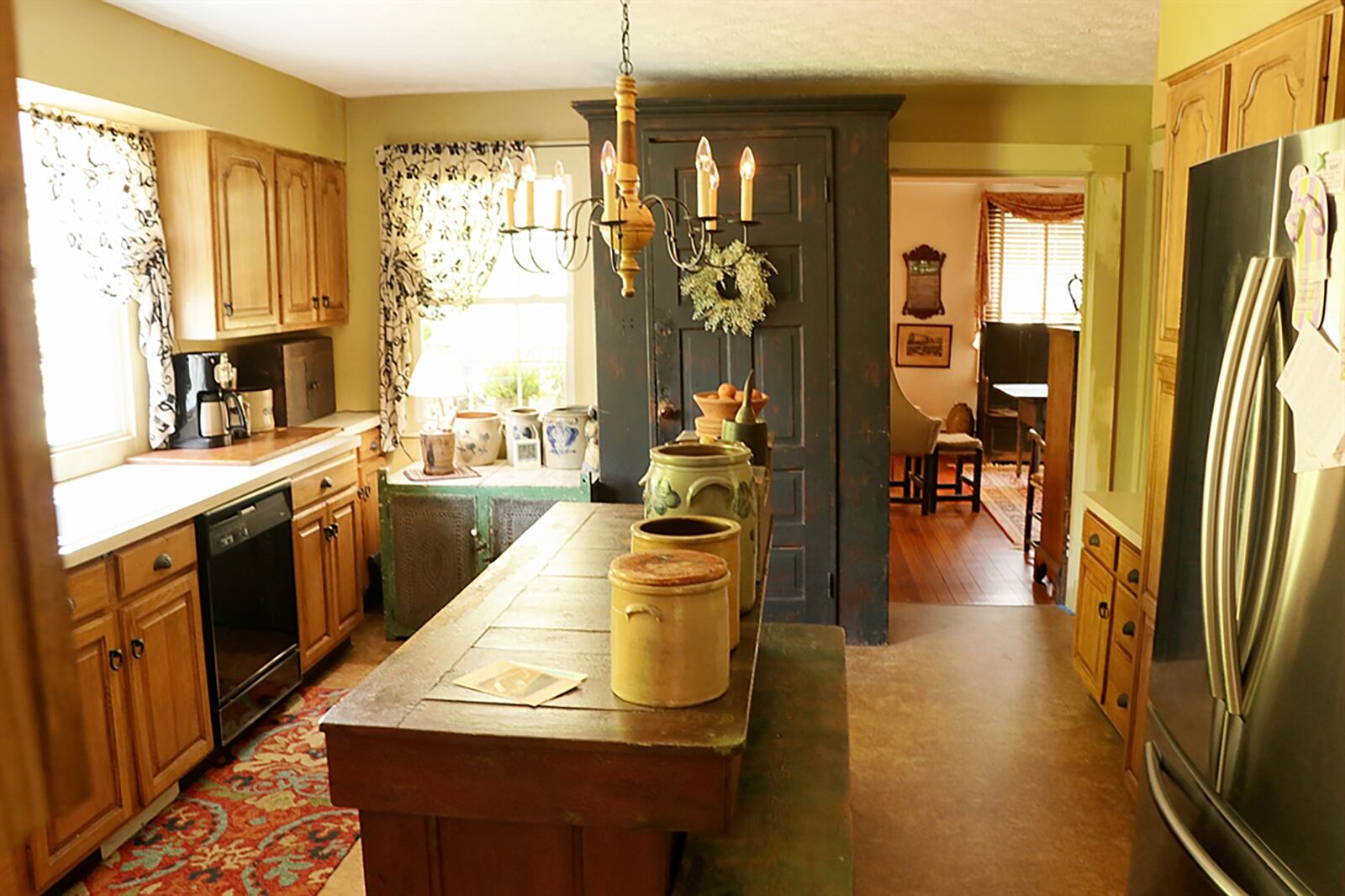 Three walls of cabinetry give the kitchen plenty of storage as two large windows are above the double sink. A planning desk or coffee station is beside the refrigerator nook, and there is a pantry cabinet with roll-out shelves. CONTRIBUTED PHOTO BY KATHY TYLER