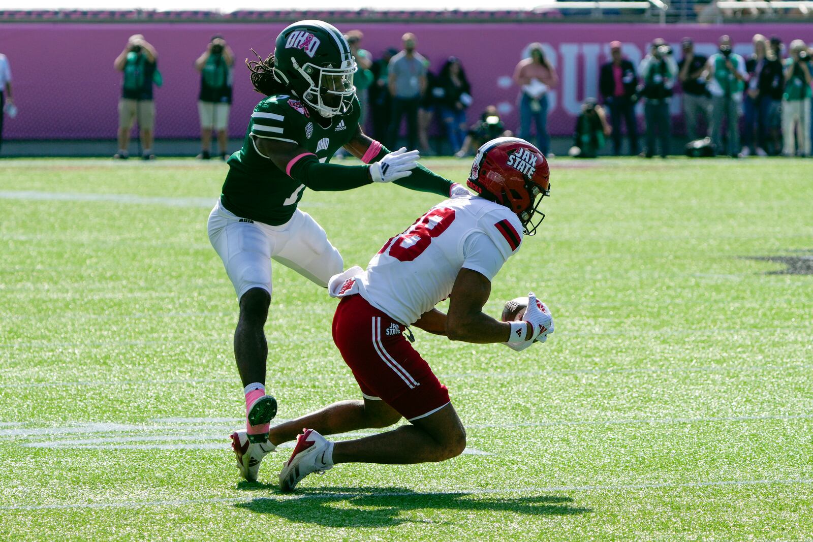 Jacksonville State wide receiver Cam Vaughn, right, makes a reception in front of Ohio cornerback Tank Pearson during the first half of the Cure Bowl NCAA college football game, Friday, Dec. 20, 2024, in Orlando, Fla. (AP Photo/John Raoux)