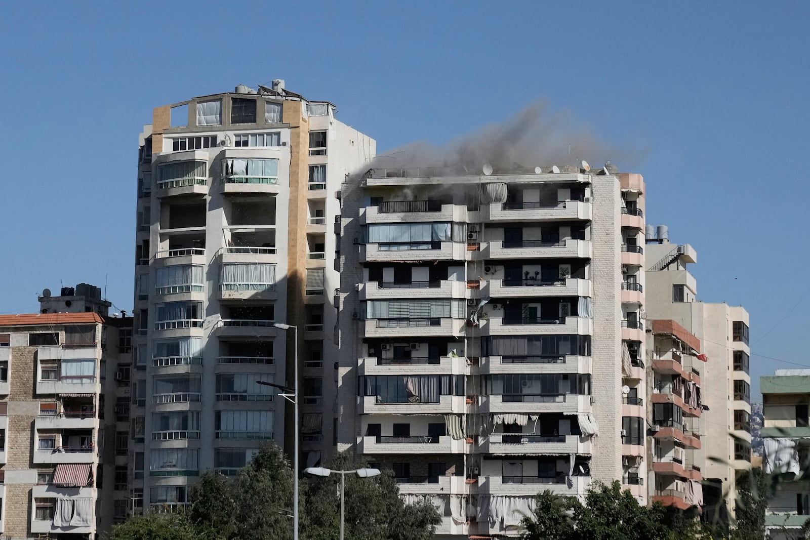 Smoke rises from a building following an Israeli warning strike, that came minutes before a bomb brought down the building, in Ghobeiri, Beirut, Lebanon, Tuesday, Oct. 22, 2024. (AP Photo/Bilal Hussein)