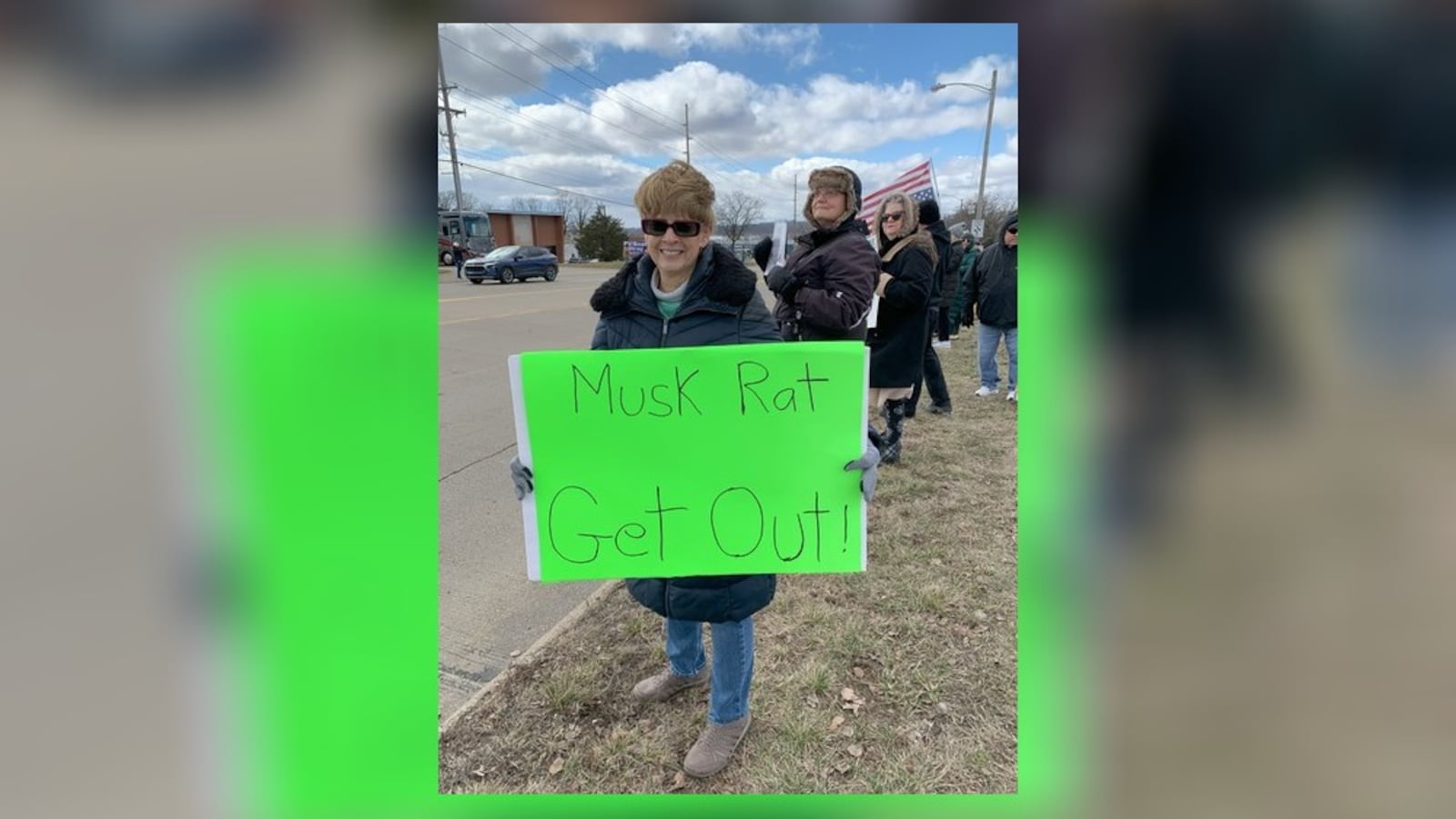 Hundreds of people lined West Dorothy Lane in Moraine on Saturday, March 1, 2025 to protest near a Tesla Service Center, including one of the organizers Kathy Jones (pictured). The protest was aimed at Elon Musk, the world's richest man, and his actions with the Trump administration and the Department of Government Efficiency. BROOKE SPURLOCK/STAFF