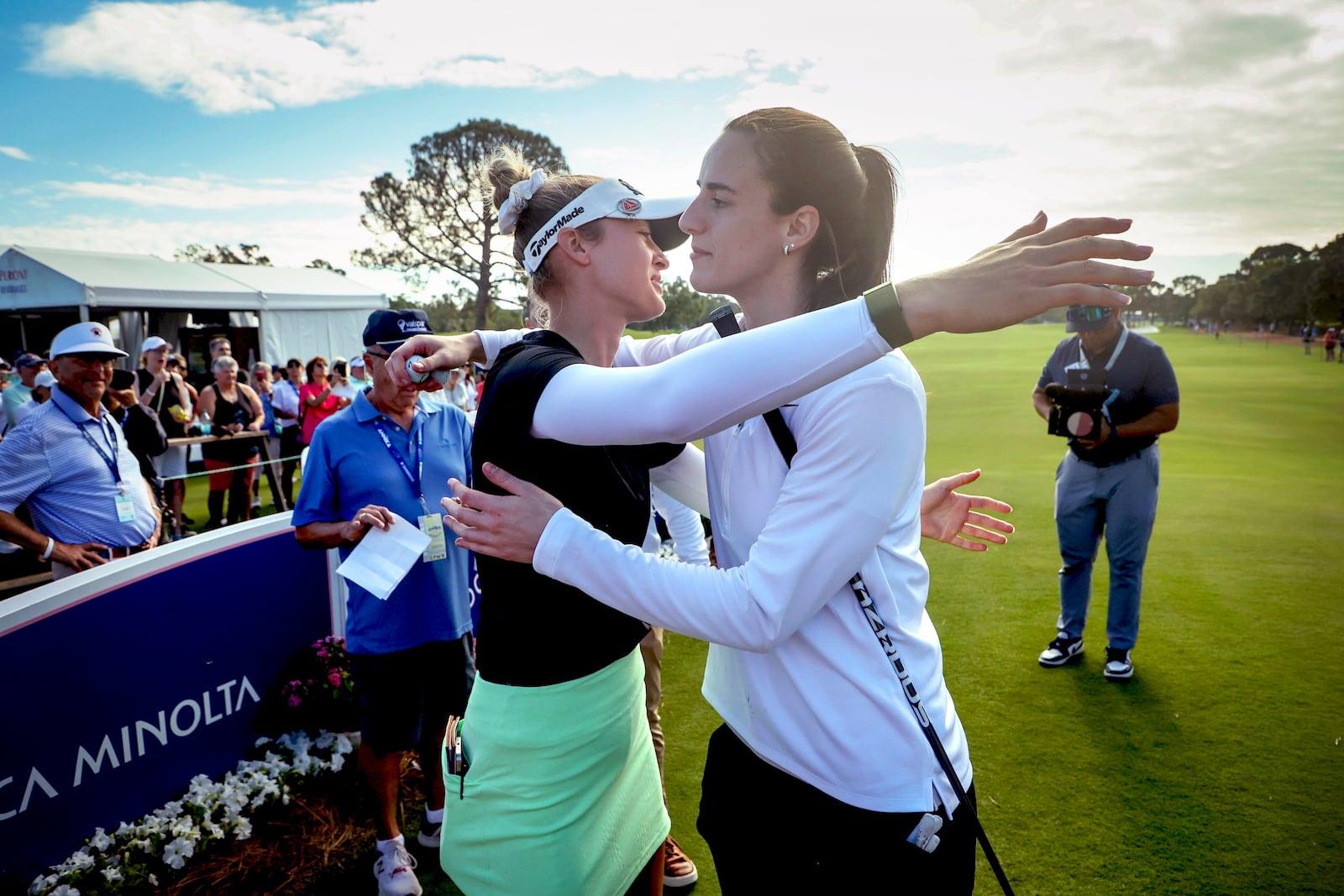 LPGA pro golfer Nelly Korda, left, embraces WNBA basketball player Caitlin Clark, of the Indiana Fever, at the 10th tee during the pro-am at the LPGA Tour golf tournament, Wednesday, Nov 13, 2024, at the Pelican Golf Club in Belleair, Fla. (Douglas R. Clifford/Tampa Bay Times via AP)