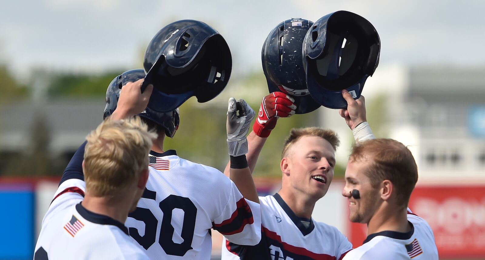 Dayton celebrates a home run by Connor Echols, second from right, against Saint Joseph’s on April 26, 2019, in Dayton. Photo by Erik Schelkun