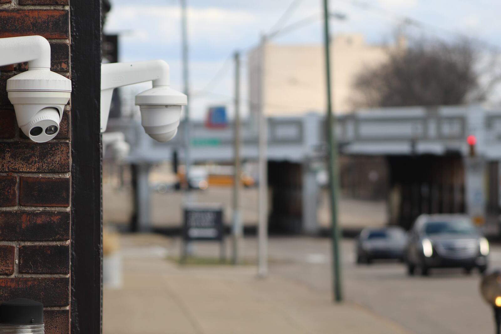 Security cameras on the outside of a building on East Third Street in the Webster Station neighborhood. CORNELIUS FROLIK / STAFF