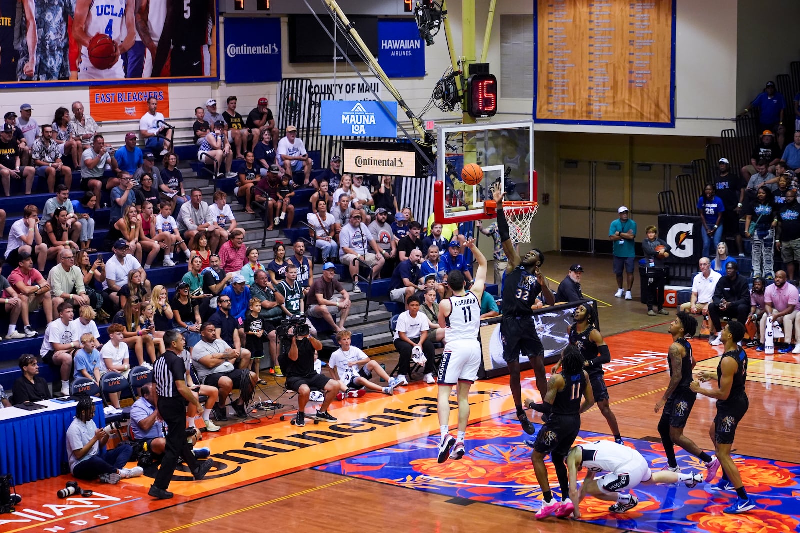 UConn forward Alex Karaban (11) shoots against Memphis center Moussa Cisse (32) during the first half of an NCAA college basketball game at the Maui Invitational Monday, Nov. 25, 2024, in Lahaina, Hawaii. (AP Photo/Lindsey Wasson)