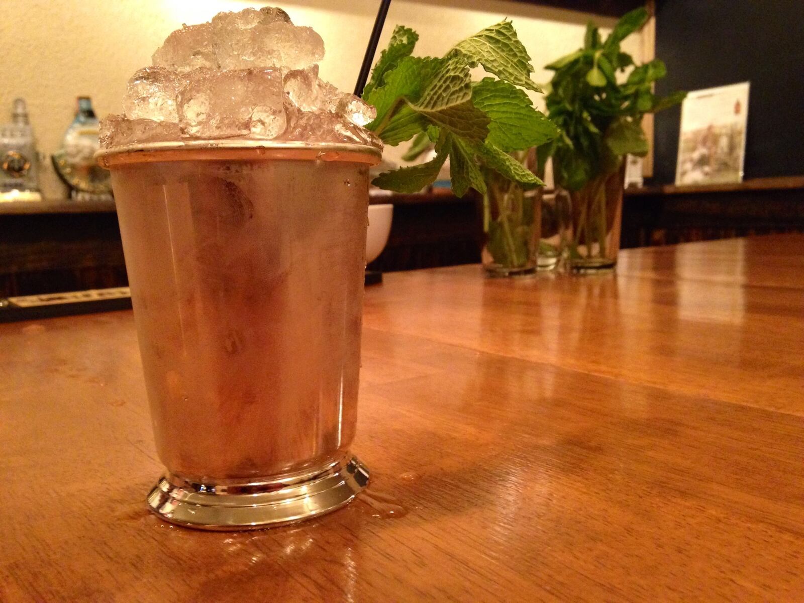 Mint Juleps are often served in steel cups like this one containing a watermelon mint julep made at the Century Bar. (Staff photo by Amelia Robinson)