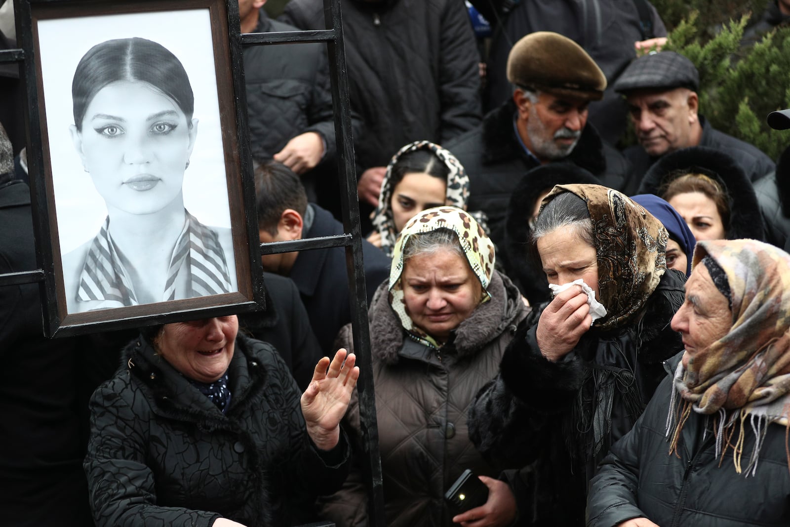 People mourn at the grave of flight attendant Hokume Aliyeva during a funeral of the crew members of the Azerbaijan Airlines Embraer 190 killed in a deadly plane crash in Kazakhstan this week, at the II Alley of Honor in Baku, Azerbaijan, Sunday, Dec. 29, 2024. (AP photo)