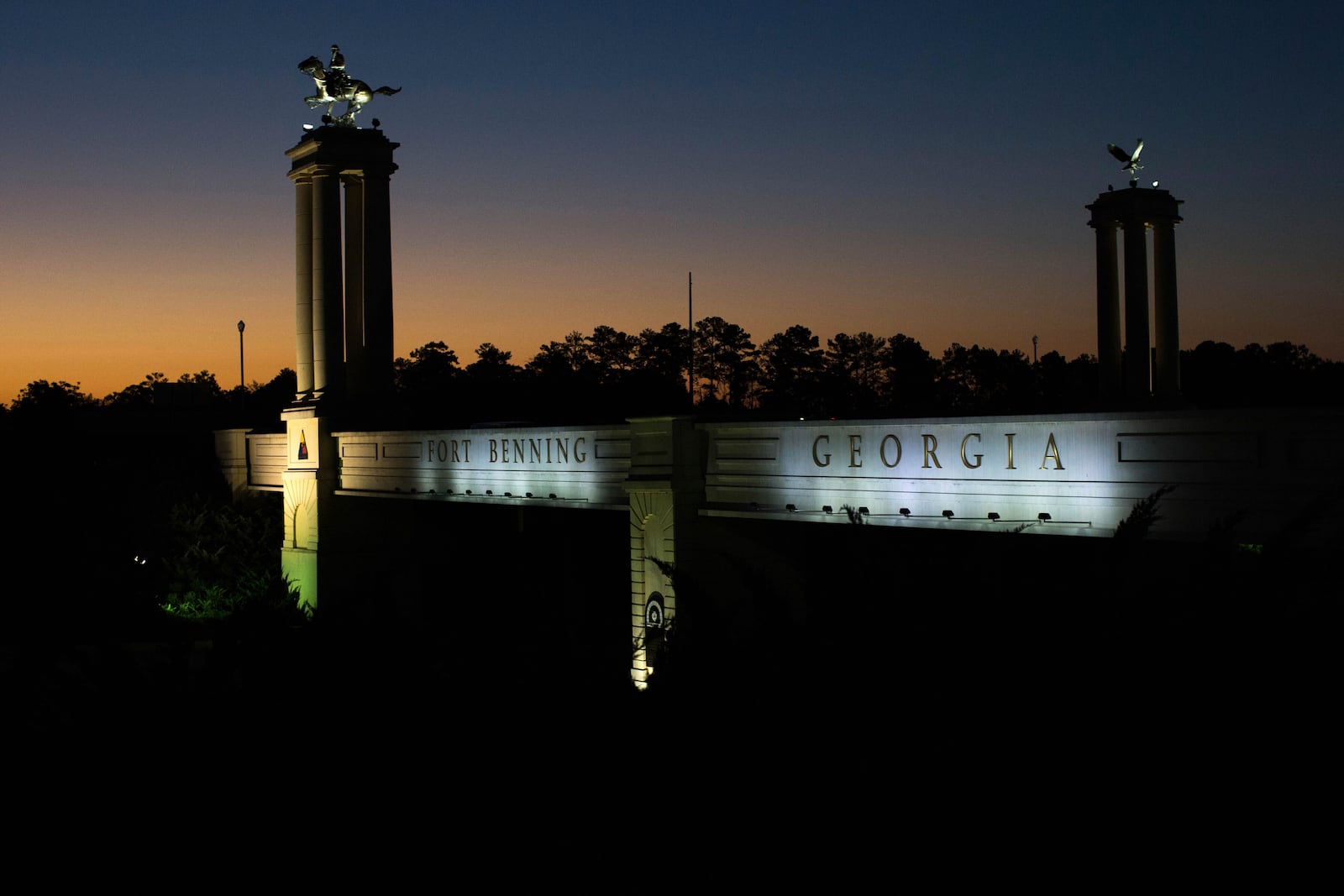 FILE - A bridge marks the entrance to the U.S. Army's Fort Benning as the sun rises in Columbus, Ga., Oct. 16, 2015. (AP Photo/Branden Camp, File)