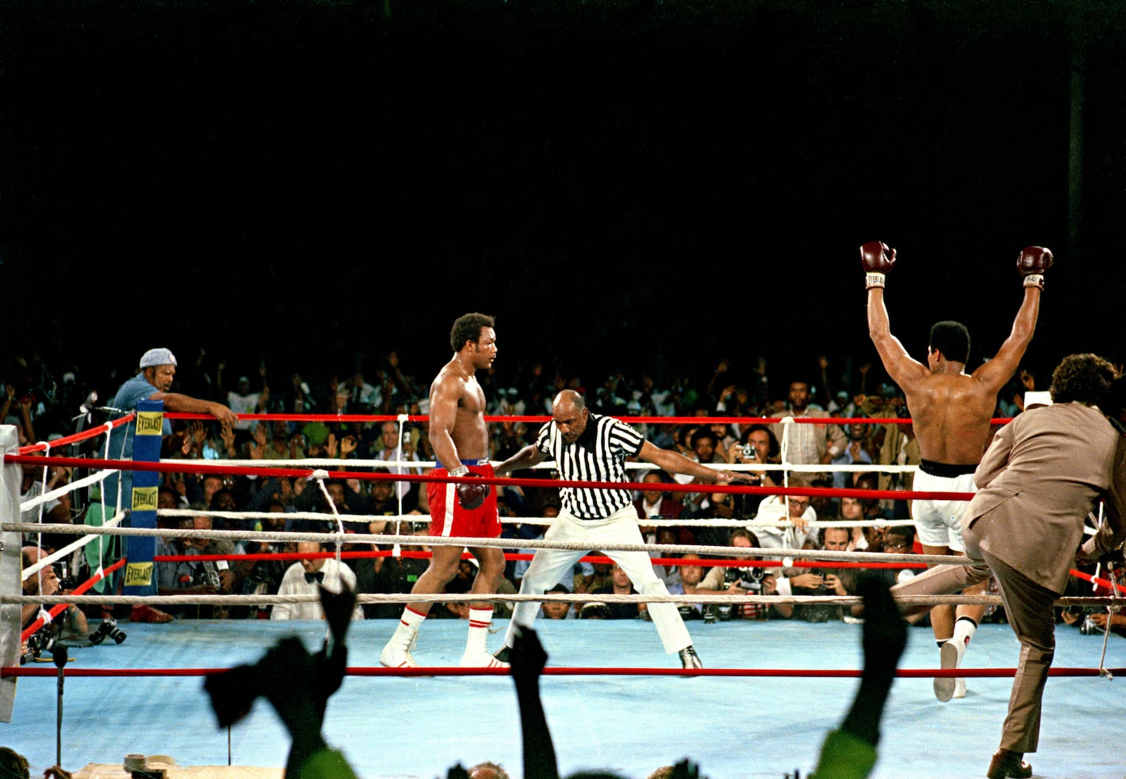 FILE - Challenger Muhammad Ali raises his arms in victory after defending champion George Foreman is counted out by referee Zack Clayton, ending the WBA/WBC championship bout in Kinshasa, Zaire, on Oct. 30, 1974. (AP Photo, File)