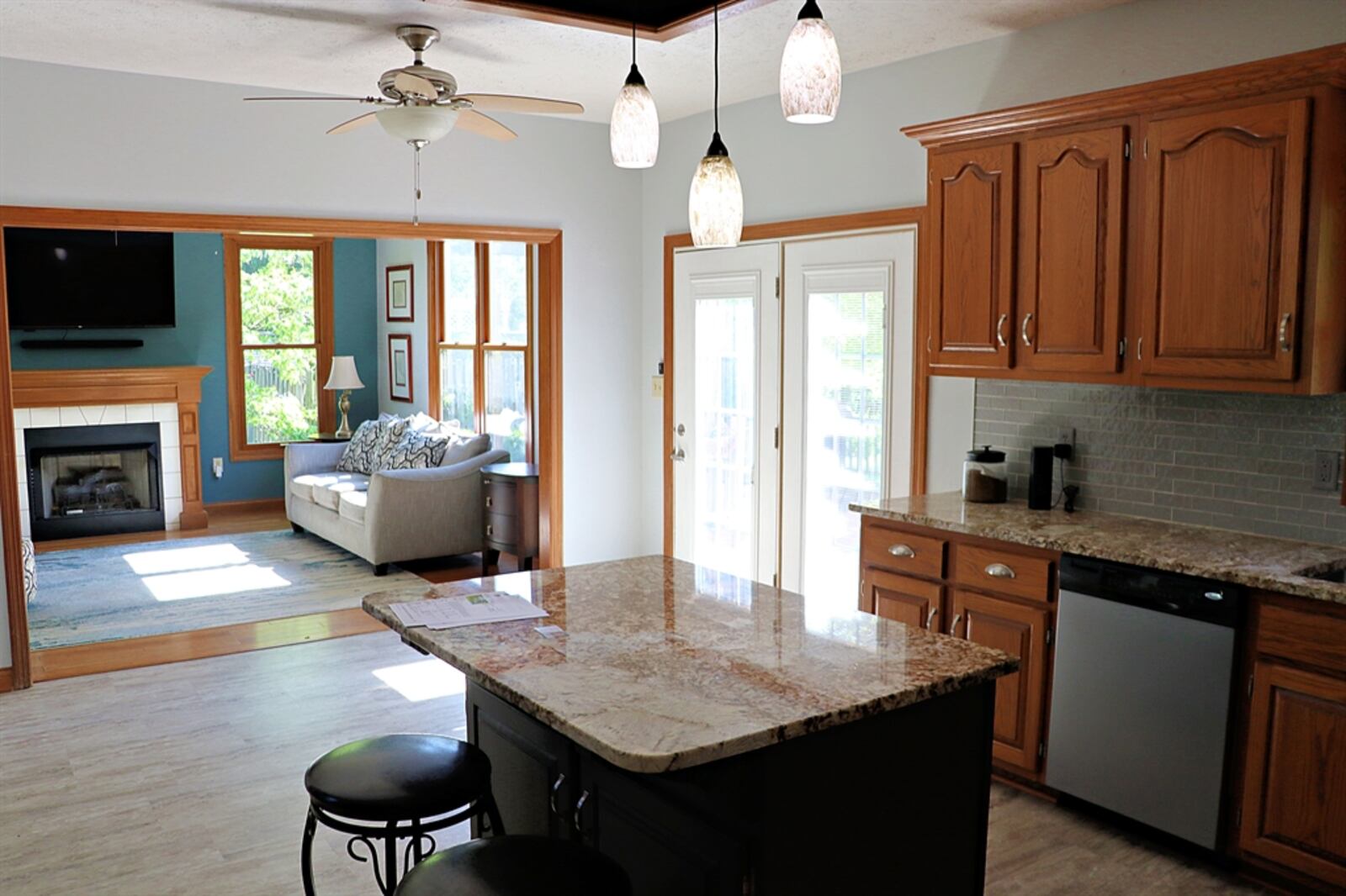 The kitchen has been updated with granite counters. There is a window above the sink and an island has an extended counter to offer bar seating for two. 