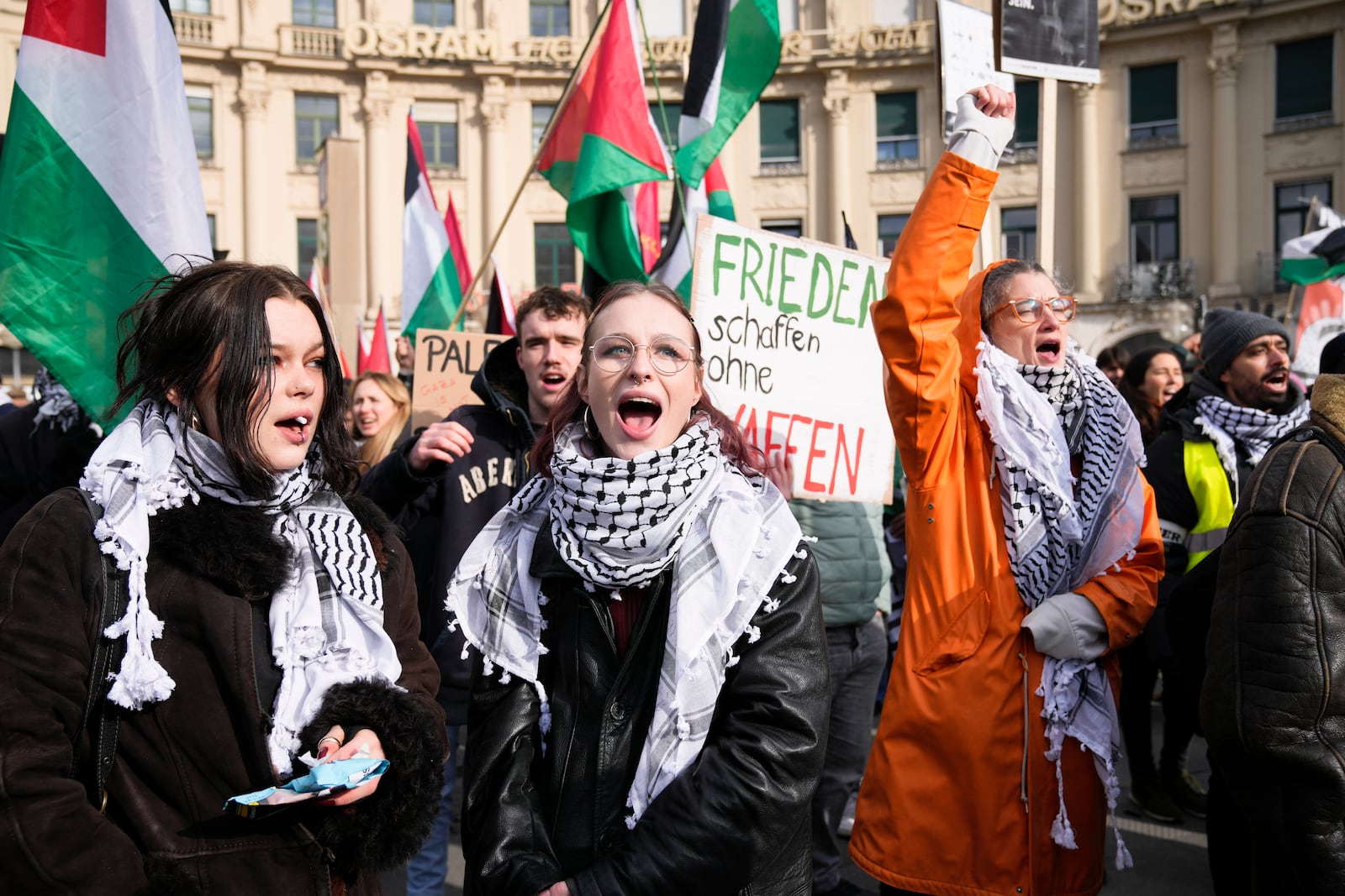 Protestors shout slogan during a protest against the Munich Security Conference in Munich, Saturday, Feb. 15, 2025. Central poster reads: 'Make peace without weapons".(AP Photo/Ebrahim Noroozi)