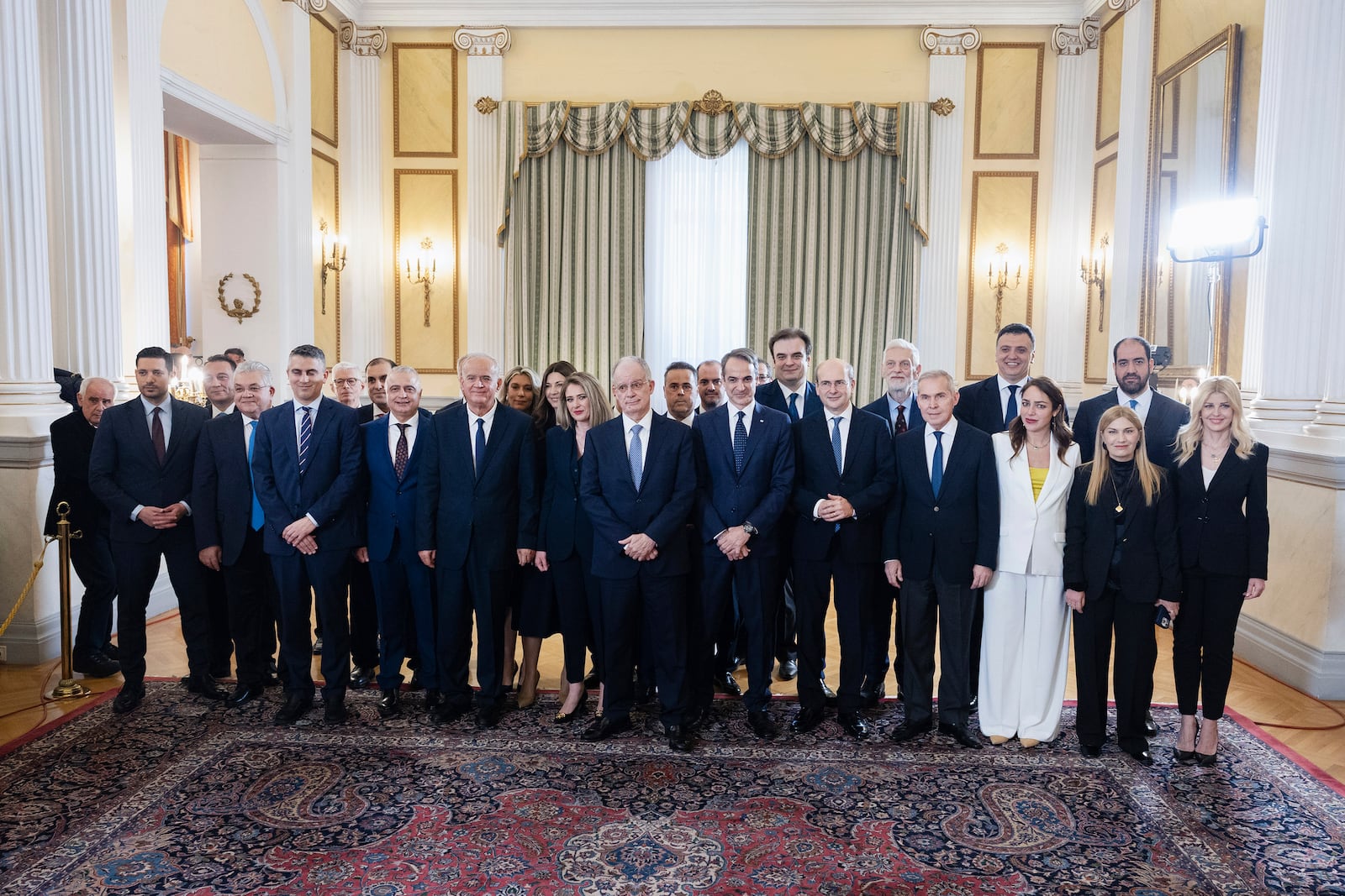 Greece's government newly appointed members pose for a family photograph following a swearing in ceremony at the Presidential palace, in Athens, Greece, Saturday, March 15, 2025. (AP Photo/Yorgos Karahalis)