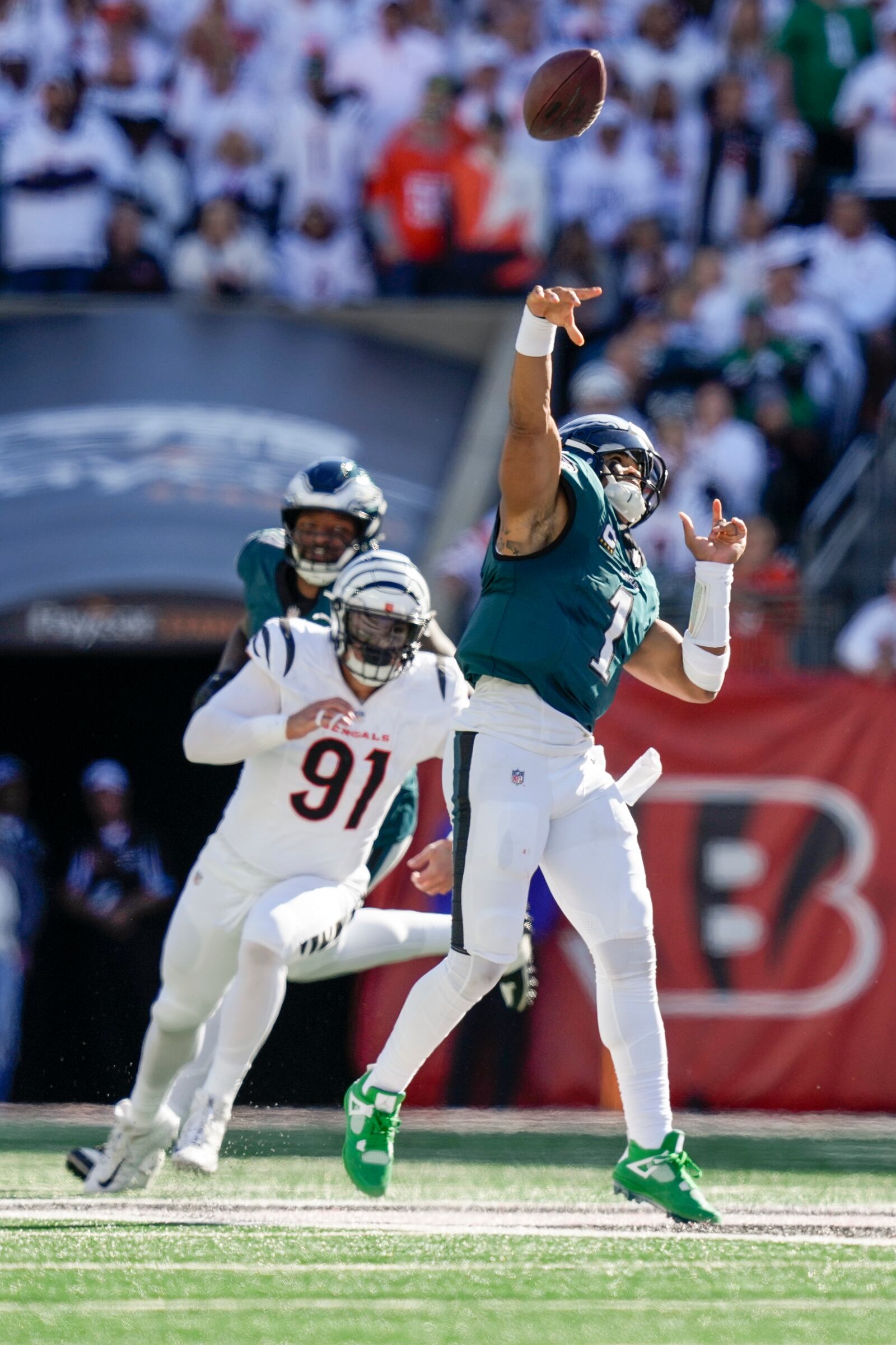 Philadelphia Eagles quarterback Jalen Hurts (1) launches a long touchdown pass to wide receiver DeVonta Smith during the second half of an NFL football game against the Cincinnati Bengals, Sunday, Oct. 27, 2024 in Cincinnati. (AP Photo/Carolyn Kaster)