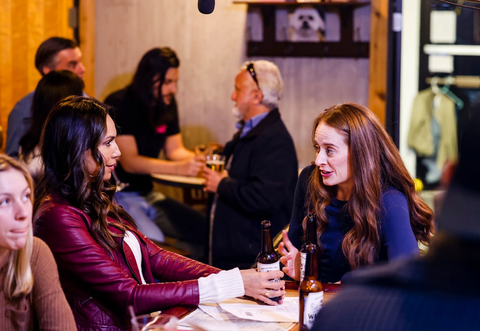 United Front Films along with M5 Entertainment, cast and local extras film scenes for the movie "A Bachelor's Valentine" Wednesday, Jan. 26, 2022 at White Dog Saloon & Distilling Company in Middletown. Laura Radi, playing Jessica Bachelor, right, and Layla Cushman, playing Claire Knapp, sit at the bar during a scene. NICK GRAHAM / STAFF