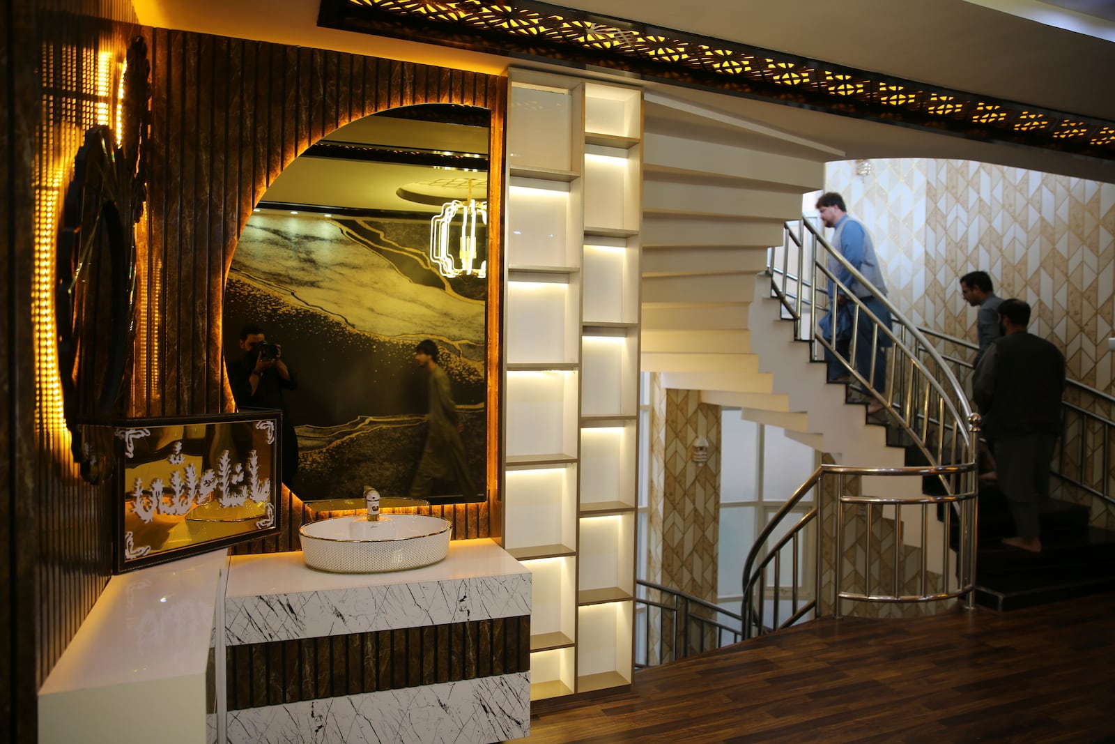 Men walk through a luxury house in the city of Kabul, Afghanistan, Sept. 23, 2024. (AP Photo/Siddiqullah Alizai)