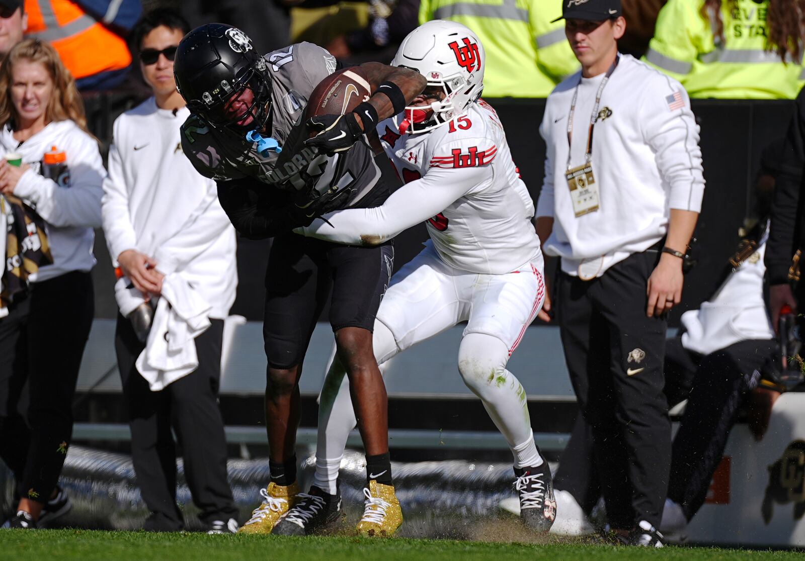 Colorado wide receiver Travis Hunter, left, is tackled by Utah safety Tao Johnson after pulling in a pass in the second half of an NCAA college football game Saturday, Nov. 16, 2024, in Boulder, Colo. (AP Photo/David Zalubowski)