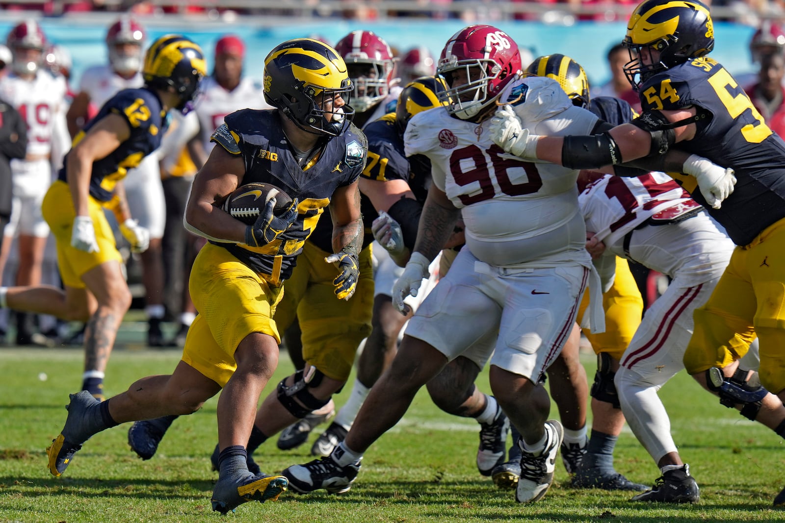 Michigan running back Jordan Marshall (23) carries the ball against Alabama during the second half of the ReliaQuest Bowl NCAA college football game Tuesday, Dec. 31, 2024, in Tampa, Fla. (AP Photo/Chris O'Meara)