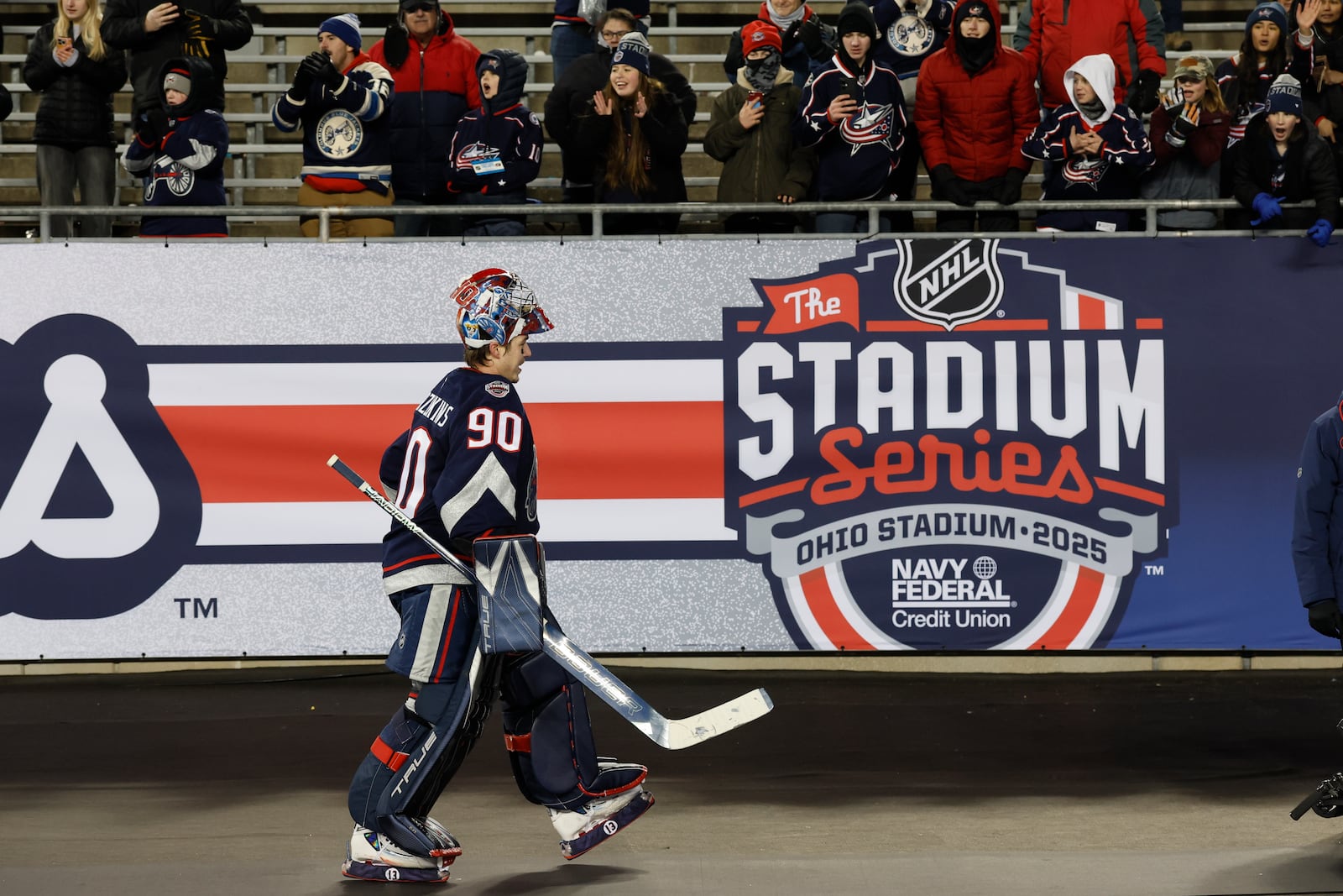 Columbus Blue Jackets' Elvis Merzlikins walks past fans after their win over the Detroit Red Wings during the Stadium Series NHL hockey game at Ohio Stadium, Saturday, March 1, 2025, in Columbus, Ohio. (AP Photo/Jay LaPrete)