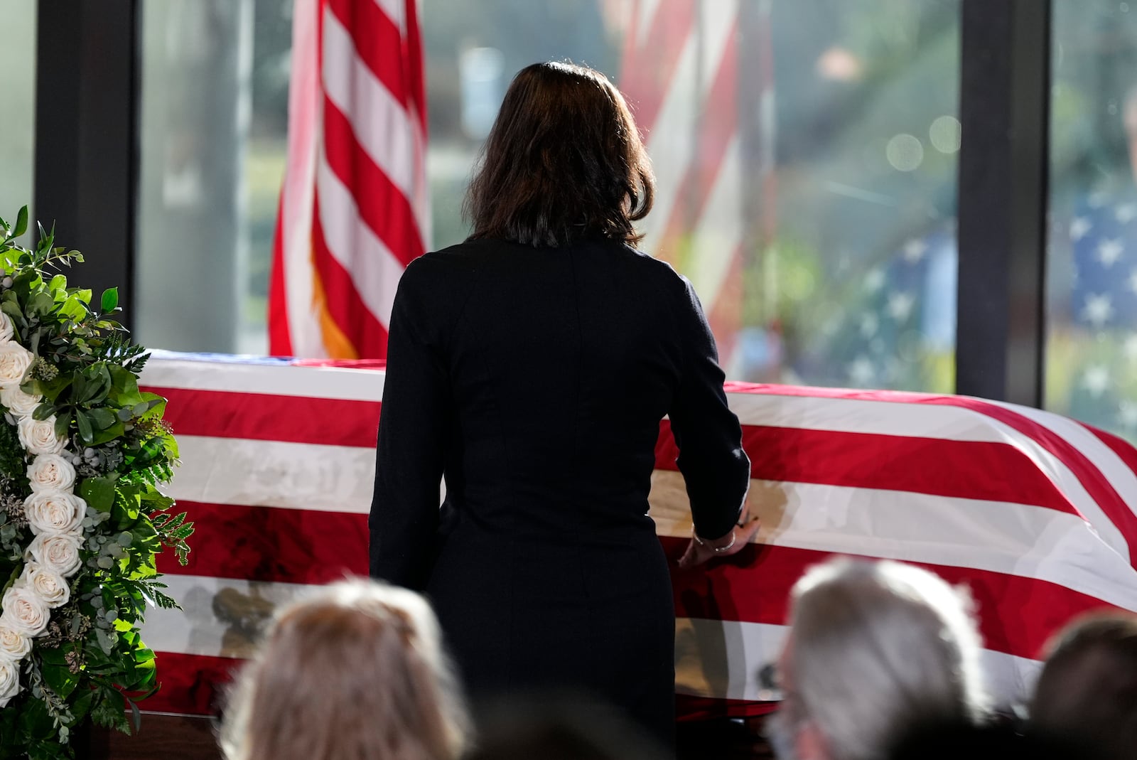 Paige Alexander, CEO of The Carter Center, touches the casket, as Amy Carter and her husband John Joseph "Jay" Kelly, foreground, watch, during a service for former President Jimmy Carter at the Jimmy Carter Presidential Library and Museum in Atlanta, Saturday, Jan. 4, 2025. Carter died Dec. 29 at the age of 100. (AP Photo/Alex Brandon, Pool)