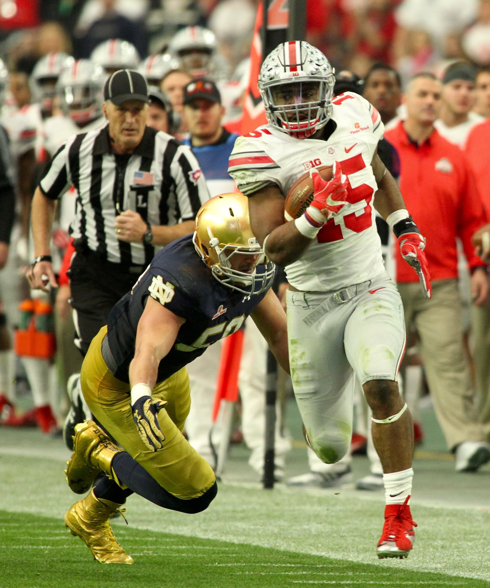 Ohio State’s Ezekiel Elliott carries the ball in the first quarter against Notre Dame in the Fiesta Bowl on Friday, Jan. 1, 2016, at University of Phoenix Stadium in Glendale, Ariz. David Jablonski/Staff