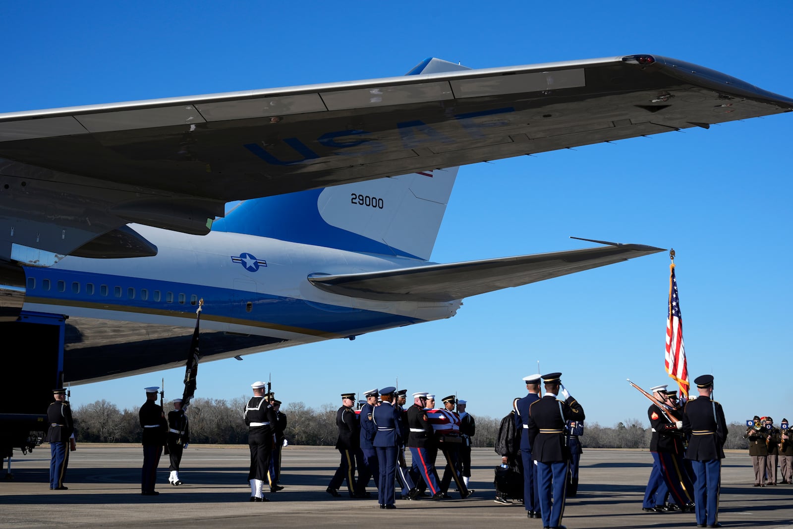 The flag-draped casket of former President Jimmy Carter carried by a joint services body bearer team from Special Air Mission 39 at Lawson Army Airfield, in Fort Moore, Ga., Thursday, Jan. 9, 2025. (AP Photo/Alex Brandon, Pool)