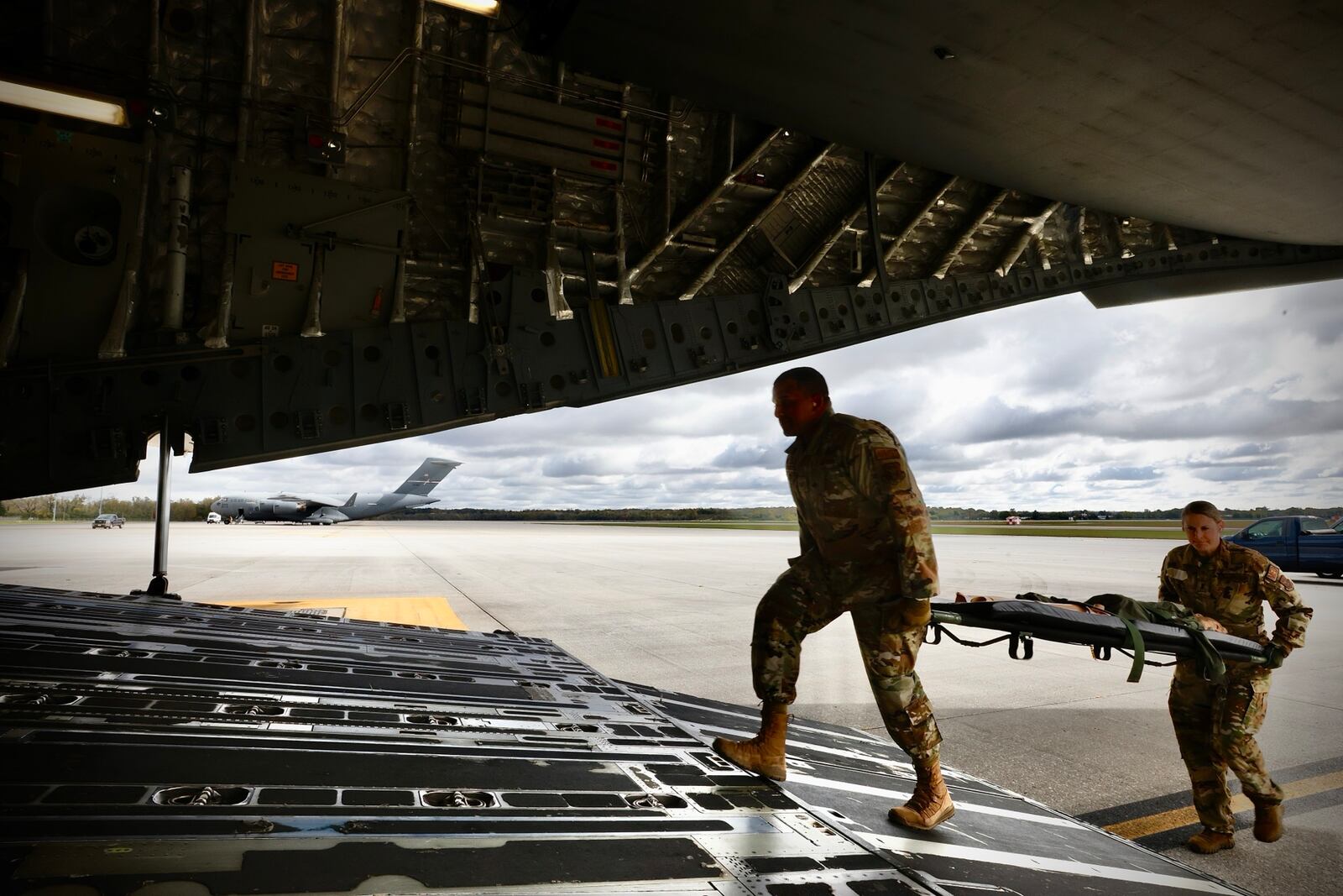 Crewmembers of a C-17 Globemaster III load dummies onto the aircraft during a mock medical evacuation drill at Wright Patterson Air Force Base, Wednesday, October 16, 2024. MARSHALL GORBY \STAFF