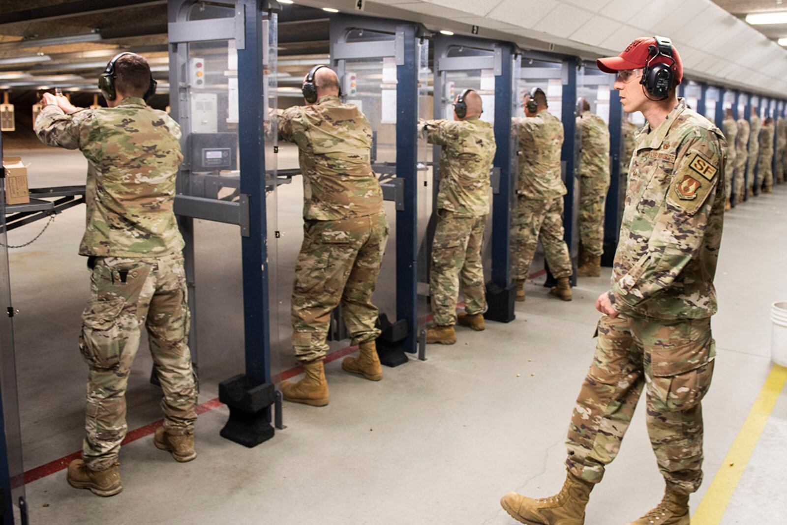 An 88th Security Forces Squadron combat arms instructor watches participants fire during the M18 9mm pistol Excellence in Competition shooting event held as part of Police Week at Wright-Patterson Air Force Base. U.S. AIR FORCE PHOTO/WESLEY FARNSWORTH