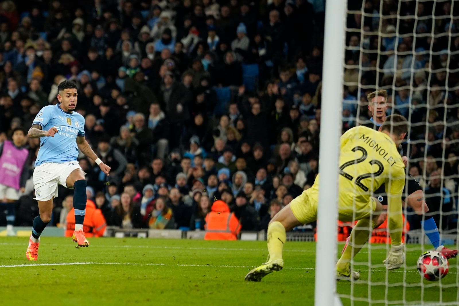 Manchester City's Savinho, left, scores his side's third goal during the Champions League opening phase soccer match between Manchester City and Club Brugge at the Etihad Stadium in Manchester, Wednesday, Jan. 29, 2025. (AP Photo/Dave Thompson)