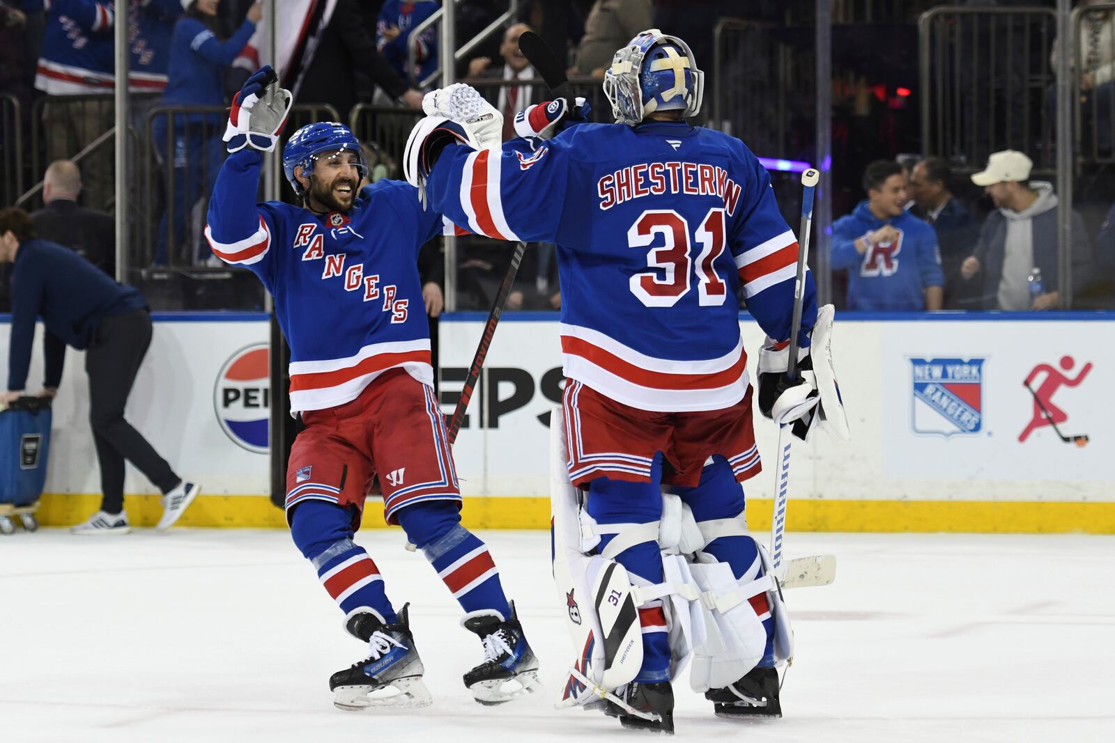 New York Rangers' Vincent Trocheck, left, and New York Rangers' Igor Shesterkin, right, celebrate defeating the Columbus Blue Jackets during overtime of an NHL hockey game Saturday, Jan. 18, 2025, in New York. (AP Photo/Pamela Smith)