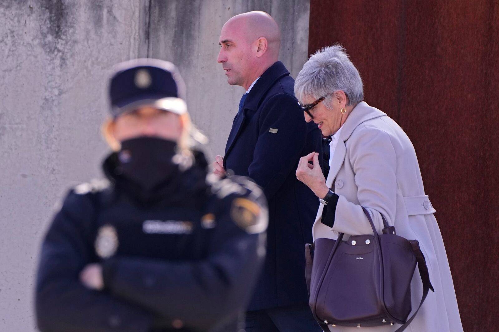 The former president of Spain's soccer federation Luis Rubiales, centre, leaves a court with his lawyer Olga Tubau on the outskirts of Madrid, Spain, Monday Feb. 3, 2025 where he is on trial for his unsolicited kiss on forward Jenni Hermoso. (AP Photo/Manu Fernandez)