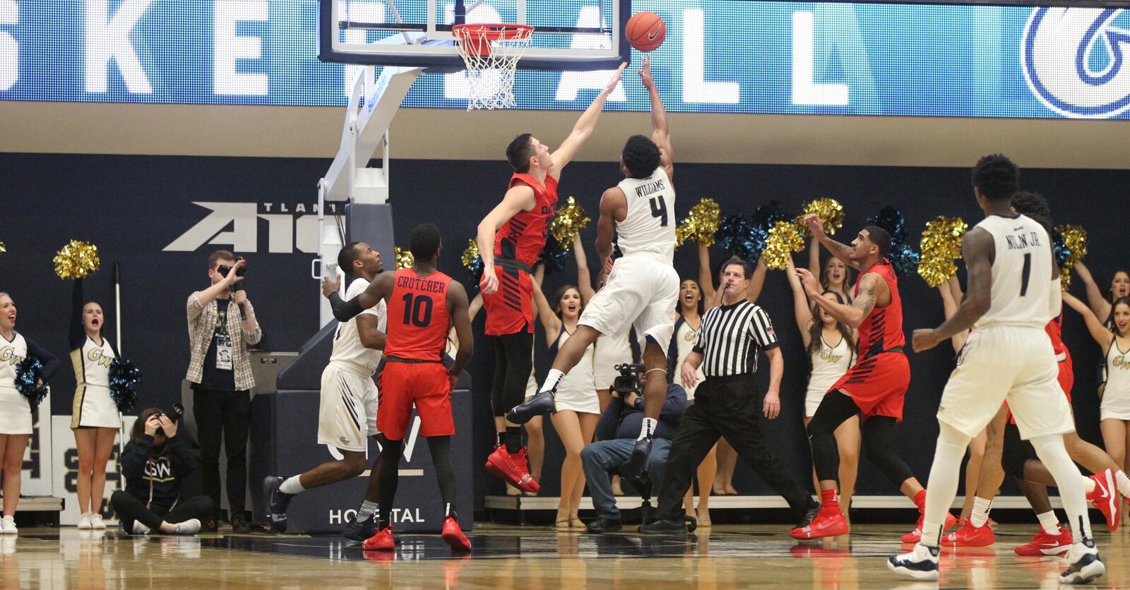 George Washington’s Justin Williams shoots against Dayton’s Ryan Mikesell on Wednesday, Jan. 9, 2019, at the Charles E. Smith Center in Washington, D.C.