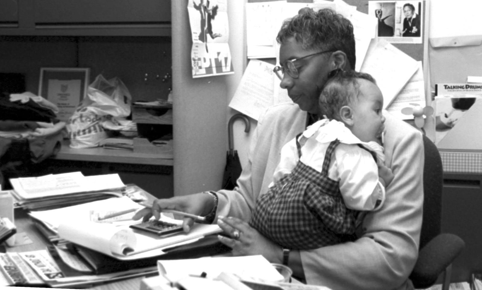 Jeraldyne Blunden, founder of the Dayton Contemporary Dance Company, juggles office work and babysitting for her granddaugher Lyndsey in this 1994 photograph. DAYTON DAILY NEWS ARCHIVE