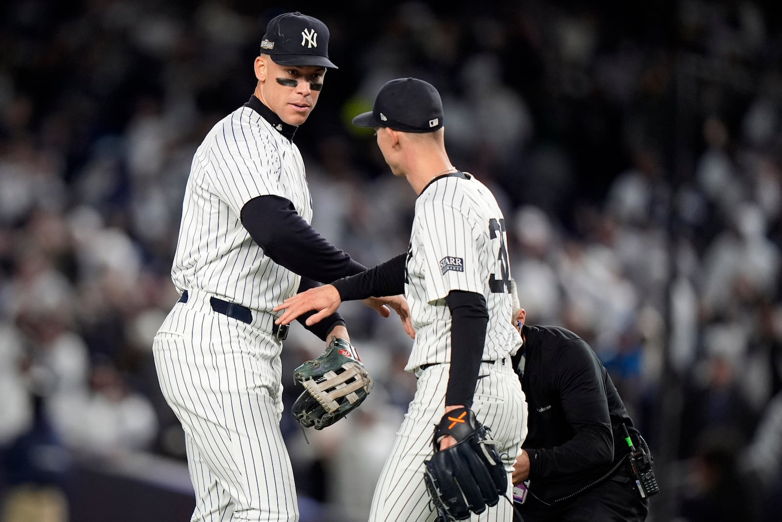 New York Yankees' Aaron Judge, left, celebrates with Luke Weaver after Game 2 of the baseball AL Championship Series against the Cleveland Guardians Tuesday, Oct. 15, 2024, in New York. The Yankees won 6-3. (AP Photo/Frank Franklin II)