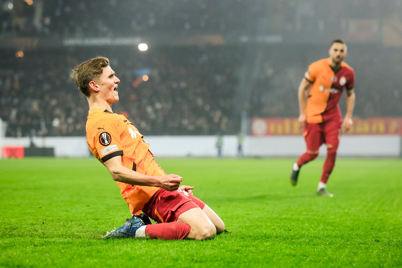 Galatasaray's Elias Jelert celebrates after scoring his side's opening goal during the Europa League opening phase soccer match between Malmo FF and Galatasaray SK at the Malmo New Stadium in Malmo, Sweden, Thursday, Dec. 12, 2024. (Andreas Hillergren/TT News Agency via AP)