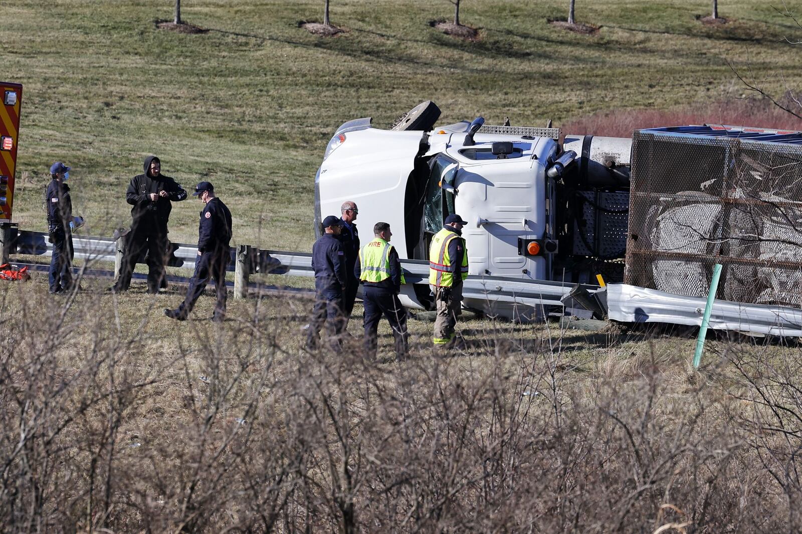 A semi hauling crushed cars rolled over on its side on the ramp from eastbound Ohio 122 to I-75 northbound in Middletown. NICK GRAHAM / STAFF