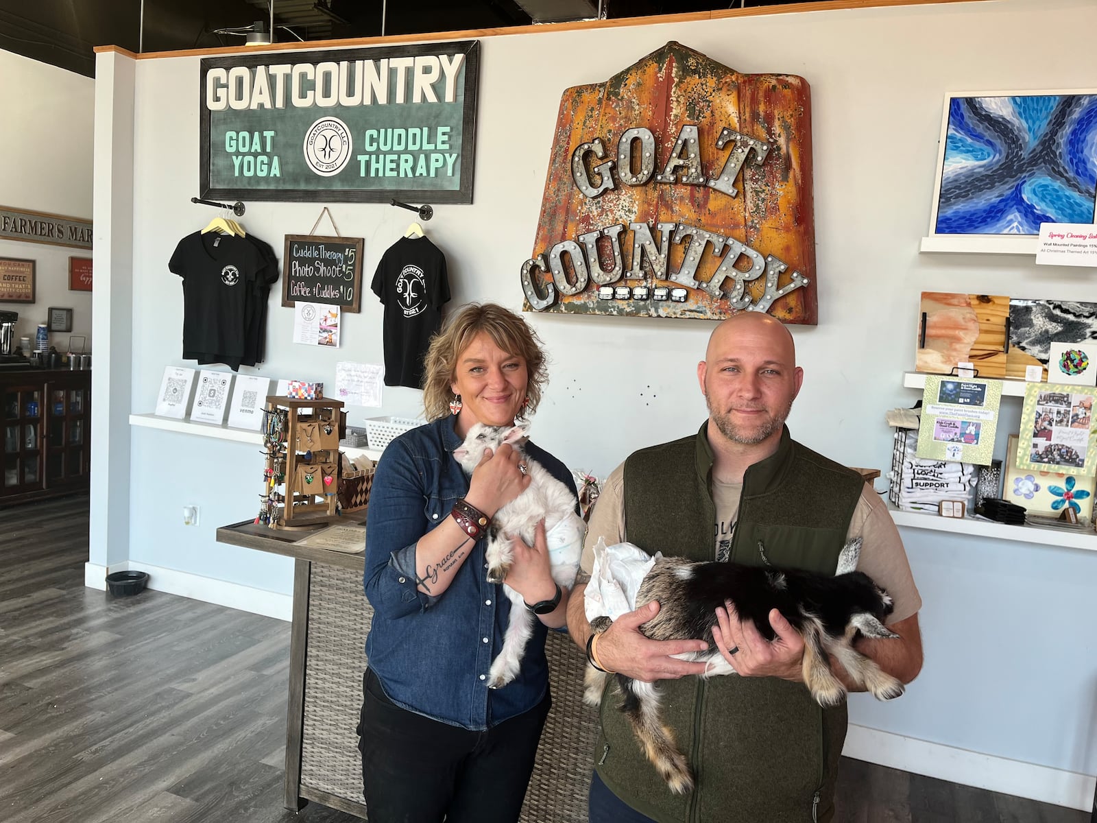 GoatCountry, located at The Greene in Beavercreek near Von Maur, offers goat cuddles, yoga and more. Pictured is owner Josh Keeton and his wife, Cassie. NATALIE JONES/STAFF