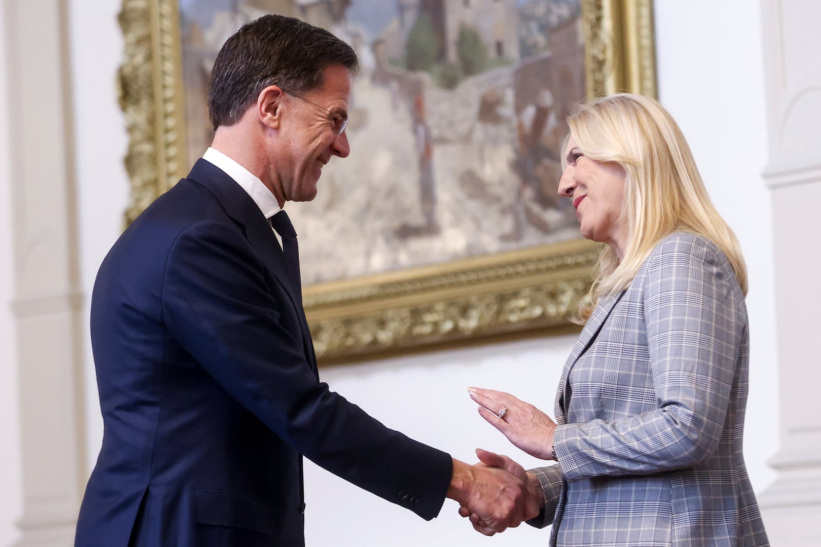 NATO Secretary General Mark Rutte, left, shakes hands with the member of the Bosnian Presidency Zeljka Cvijanovic prior to the start of their meeting in Sarajevo, Bosnia, Monday, March 10, 2025. (AP Photo/Armin Durgut)