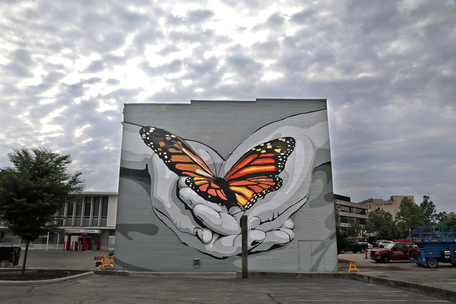 The completed “Transformation” mural on the rear wall of The State Theater shows a monarch butterfly and a pair of hands. The mural was done in conjunction with the TV production of a Disney ABC and John Legend Get Lifted Productions episode of "Finding Harmony." The mural was conceived by Columbus artist Jeremy Jarvis with the Springfield Public Arts Committee, and around 60 volunteers and local artists helped paint it.
BILL LACKEY/STAFF