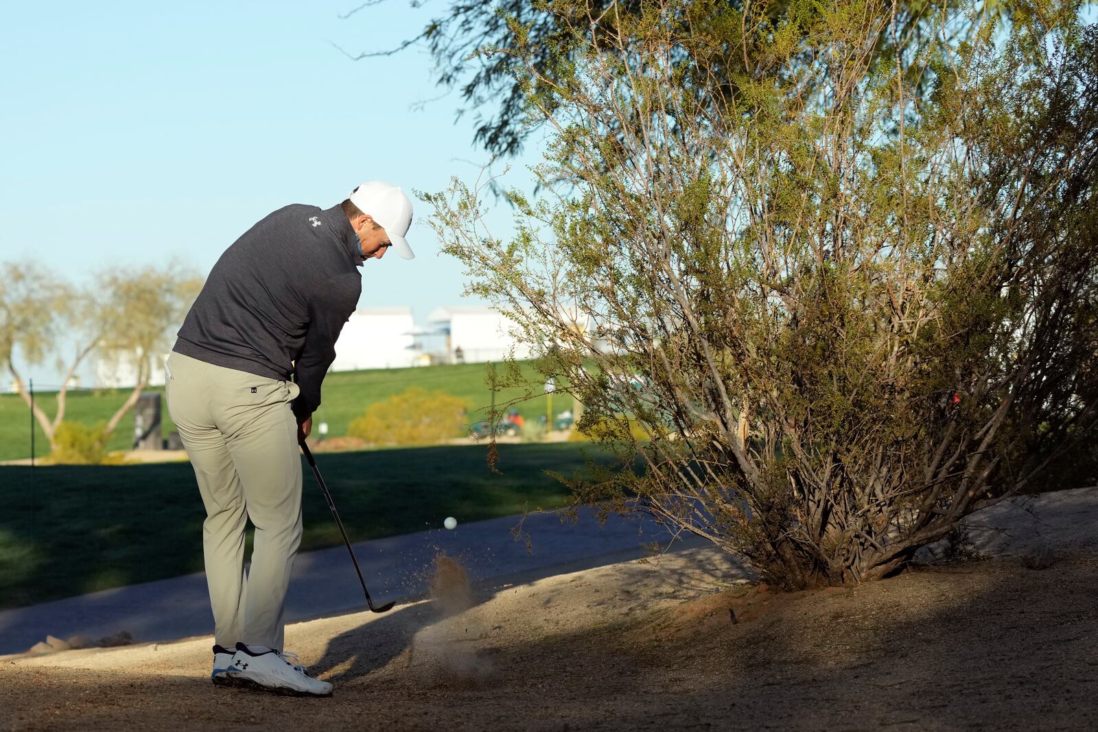 Jordan Spieth hits out of the desert on the 11th hole during the first round of the Waste Management Phoenix Open PGA Tour golf tournament at the TPC Scottsdale Thursday, Feb. 6, 2025, in Scottsdale, Ariz. (AP Photo/Ross D. Franklin)