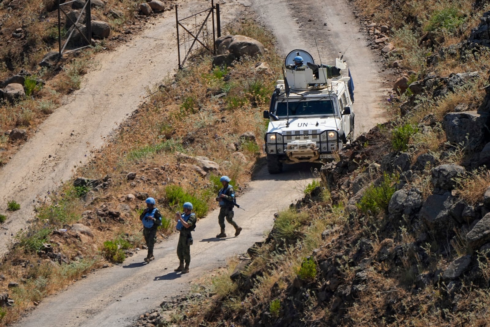 FILE -UN peacekeepers (UNIFIL) patrol along the Lebanese side of the border with Israel, seen from Israel, Thursday, July 6, 2023. (AP Photo/Ariel Schalit, File)