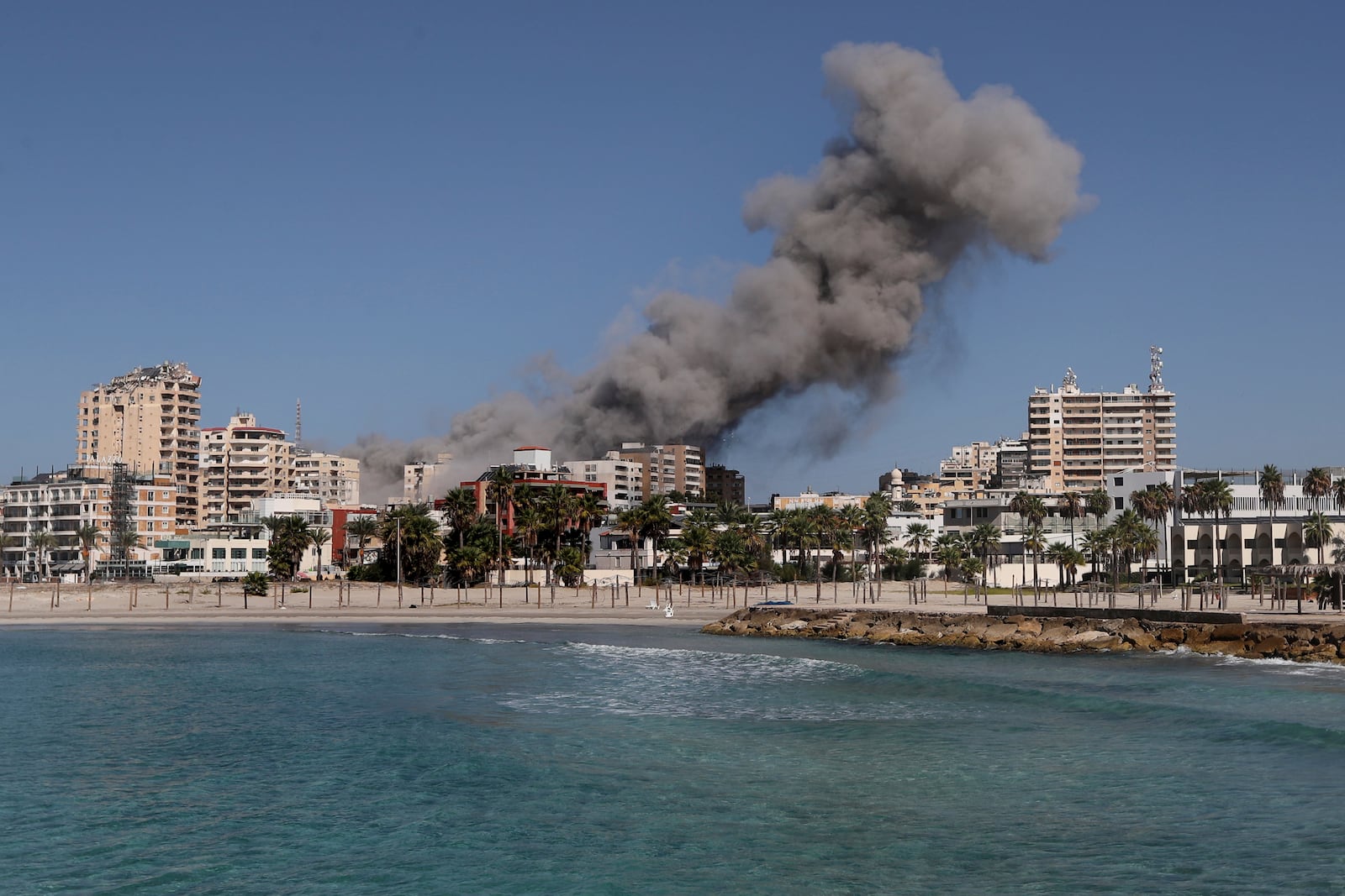 Smoke rises from buildings hit in an Israeli airstrike in Tyre, Lebanon, Wednesday, Oct. 23, 2024. (AP Photo/Mohammad Zaatari)