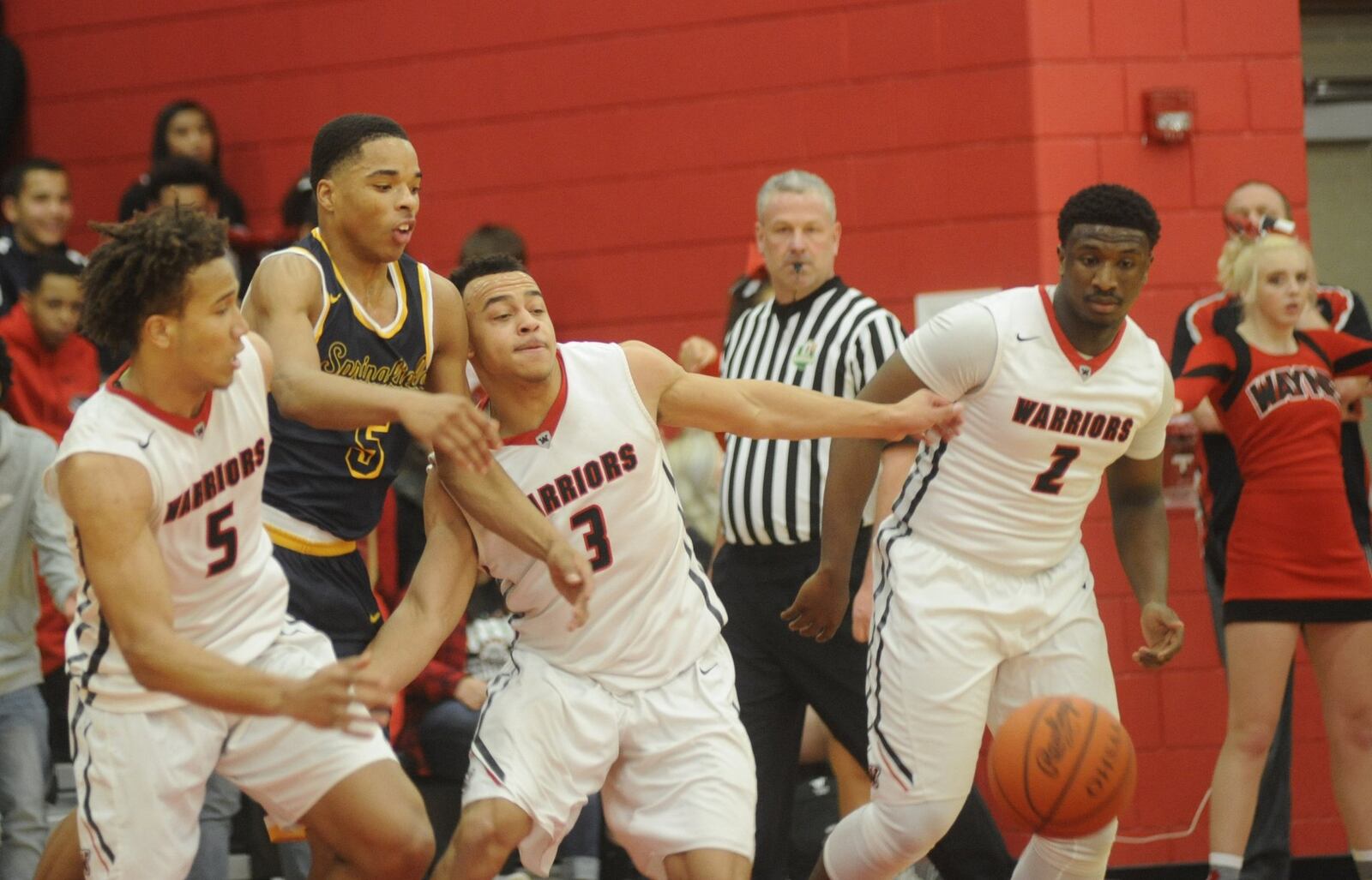 Wayne’s L’Christian “Blue” Smith (5) and teammates Darius Quisenberry (3) and Antwuan Johnson (1) battle Springfield’s Raheim Moss for a rebound. Wayne defeated visiting Springfield 65-62 in OT in a boys high school basketball game on Wed., Jan. 24, 2018. MARC PENDLETON / STAFF