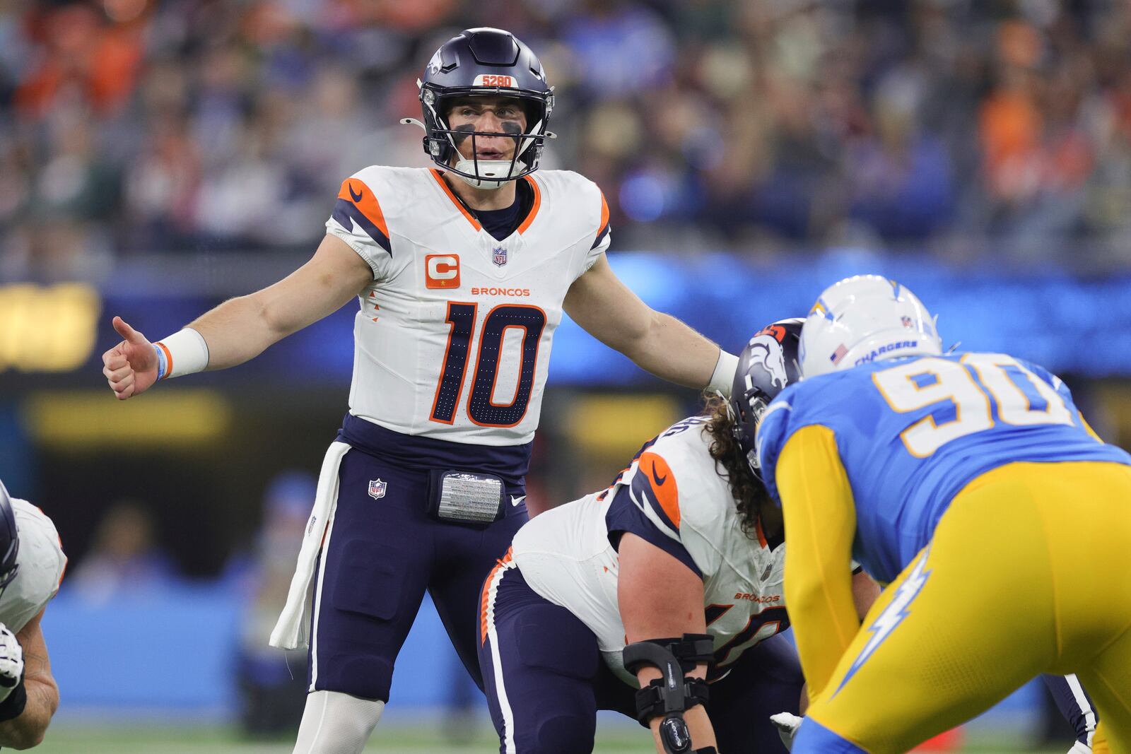 Denver Broncos quarterback Bo Nix (10) calls a play during the first half an NFL football game against the Los Angeles Chargers, Thursday, Dec. 19, 2024, in Inglewood, Calif. (AP Photo/Ryan Sun)